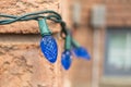 Blue Christmas lights on a brick wall - intricate patterns - festive ambiance Royalty Free Stock Photo