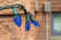 Blue Christmas lights on a brick wall - intricate patterns - festive ambiance Royalty Free Stock Photo