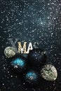 Blue Christmas or New Year background with red and blue Christmas balls, snowflakes and inscription Xmas, top view