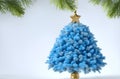 A blue Christmas tree is decorated with silver snowflakes and a gold star.The image is both festive and elegan, , and it is