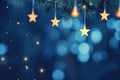 Blue Christmas Tree with Glittering Lights, Hanging Stars, and Abstract Bokeh Background Royalty Free Stock Photo