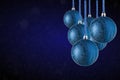 Christmas tree ornaments hanging. Balls made of glass or plastic hanging over abstract background Royalty Free Stock Photo