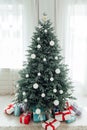 Blue Christmas tree with pine decor gifts for the new year in the interior