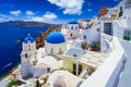 Blue church domes and white houses in the beautiful Oia town on the Santorini island, Greece Royalty Free Stock Photo