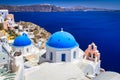 Blue church domes and white houses in the beautiful Oia town on the Santorini island, Greece Royalty Free Stock Photo