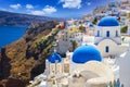 Blue church domes and white houses in the beautiful Oia town on the Santorini island, Greece Royalty Free Stock Photo