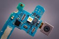 Blue circuit board from smartphone with camera module on a ribbon cable. Royalty Free Stock Photo