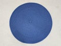 Blue Circular natural brown rattan fibers craft on white wall background.