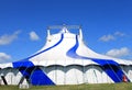 Blue circus tent in green field
