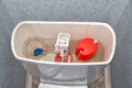 Blue cleaner water soluble tablet falls into toilet flush tank. Royalty Free Stock Photo