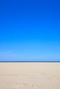 A blue clear sky with beach and ocean