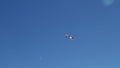 In the blue clear sky, a plane taking off is gaining altitude Royalty Free Stock Photo