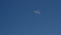 In the blue clear sky, a plane taking off is gaining altitude Royalty Free Stock Photo