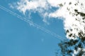 blue clear sky with a snow-white cloud close-up. the jet trail diagonally divides the sky in half. close-up. atmospheric photo of