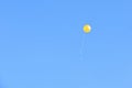 on a blue clear sky a yellow balloon Royalty Free Stock Photo