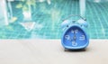 Blue clock on swimming pool edge