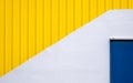 Blue close metal door on a white and yellow wall Royalty Free Stock Photo