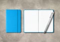 Blue closed and open lined notebooks with a pen on concrete background Royalty Free Stock Photo