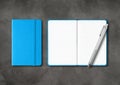 Blue closed and open lined notebooks with a pen on dark concrete background Royalty Free Stock Photo