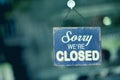 Blue closed sign in the window of a shop displaying the message Royalty Free Stock Photo