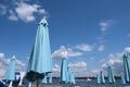 Blue closed stationary beach umbrellas Royalty Free Stock Photo