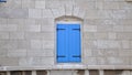 Blue closed wooden shutter on a stone house Royalty Free Stock Photo