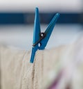 A blue clothespin is hanging on a line Royalty Free Stock Photo