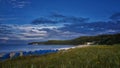 Blue clouds on the beach and blue beach chairs on island RÃÂ¼gen, Northern Germany, on the coast of Baltic Sea Royalty Free Stock Photo