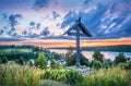 Mount Levitan in Plyos on a summer evening and a wooden cross of the churchyard. Inscription: worship cross