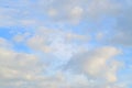 A blue cloudy sky with many small clouds blocking the su Royalty Free Stock Photo