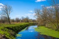 Blue and cloudy sky over a little creek in the surrounding countryside of Berlin