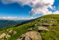 Blue cloudy sky over the mountains with rocky hillside Royalty Free Stock Photo