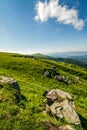 Blue cloudy sky over the mountains with rocky hillside Royalty Free Stock Photo