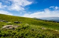 Blue cloudy sky over the mountains with rocky hillside Royalty Free Stock Photo