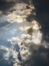 Blue cloudy sky with sunbeams