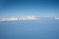 Blue cloudy sky, view from the airplane window. Aerial view of cloudscape Royalty Free Stock Photo