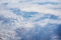 Blue cloudy sky, view from the airplane window. Aerial view of cloudscape Royalty Free Stock Photo