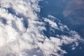 Blue cloudy sky, view from the airplane window. Aerial view of cloudscape Royalty Free Stock Photo