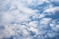 Blue cloudy sky, view from the airplane window. Aerial view of cloudscape Royalty Free Stock Photo