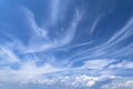 Blue cloudy sky with white cirrus clouds. Soft focus