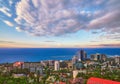 Blue coast of Black Sea in Sochi city with residential houses and recreation areas under summer cloudy sky