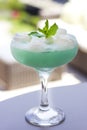 Blue cocktail in a beautiful glass with ice cream and green mint Royalty Free Stock Photo