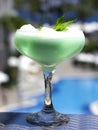 Blue cocktail in a beautiful glass with ice cream and green mint Royalty Free Stock Photo