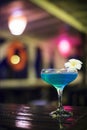 Blue cocktail drink in dark bar interior Royalty Free Stock Photo