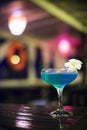 Blue cocktail drink in dark bar interior Royalty Free Stock Photo