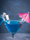 Blue cocktail in martini glass with umbrella Royalty Free Stock Photo