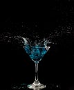 Blue Cocktail Glass with splashing water alcohol, Crystal Cocktail drink splatter splash in air and bubble from glass. Liquor Part Royalty Free Stock Photo