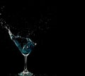 Blue Cocktail Glass with splashing water alcohol, Crystal Cocktail drink splatter splash in air and bubble from glass. Liquor Part Royalty Free Stock Photo