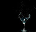 Blue Cocktail Glass with splashing water alcohol, Crystal Cocktail drink splatter splash in air and bubble from glass. Liquor Part Royalty Free Stock Photo