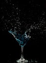 Blue Cocktail Glass with splashing water alcohol, Crystal Cocktail drink splatter splash in air and bubble from glass. Liquor Part Royalty Free Stock Photo